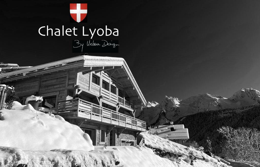 a building on top of a snow covered mountain at CHALET LYOBA in Le Grand-Bornand