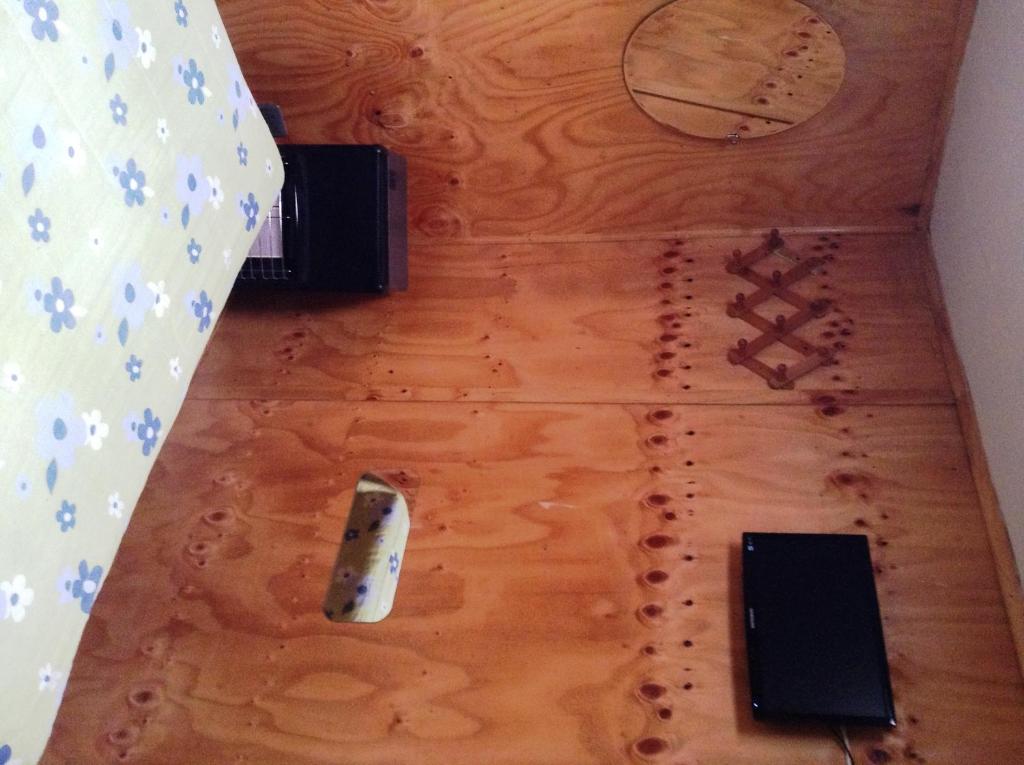 a wooden floor with several objects on it at Hostel 1760 in Talca