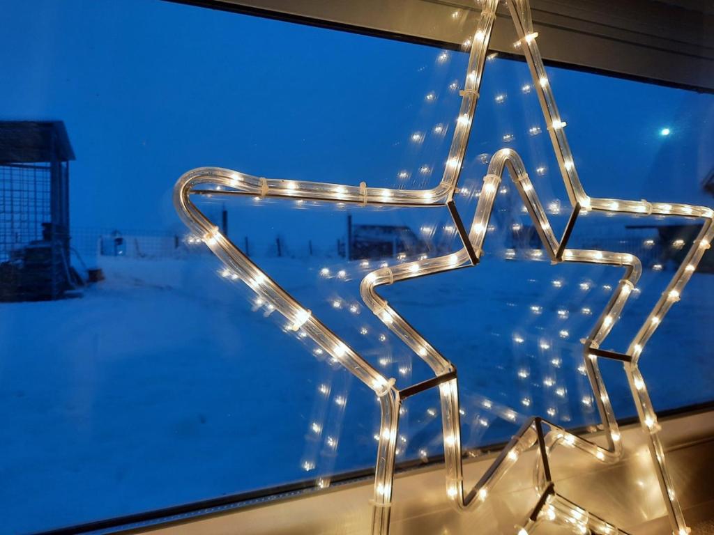 a star decoration in front of a window with lights at Villa Jasikovac in Berane