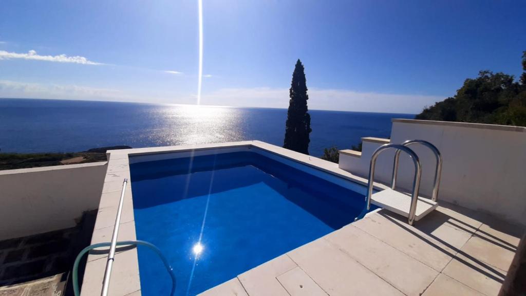 a swimming pool on the roof of a house at BLU SUITE COTTAGE SUL MARE e SWIMMING POOL in Tricase
