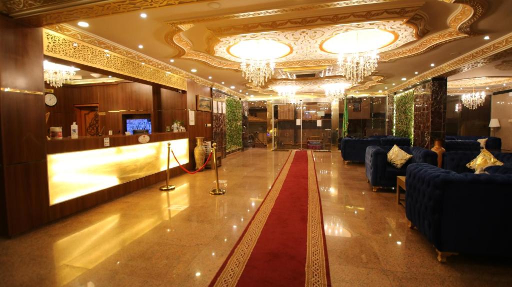 a lobby with couches and a red carpet at Ghasaq Al Leil Aparthotel in Taif
