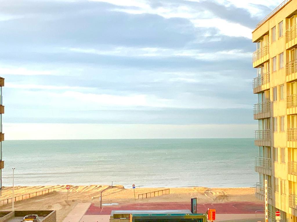 a view of the beach from a building at Luxury Suite Koksijde 201 - Adult Only in Koksijde