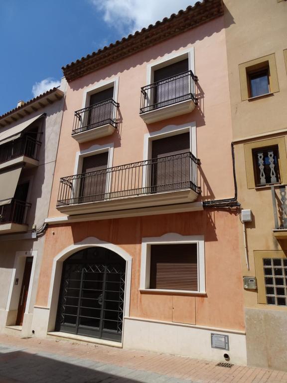 a building with balconies on the side of it at Ca la Victòria in Vinyols i els Arcs