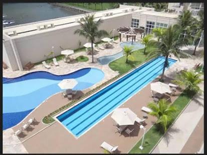 an overhead view of a swimming pool at a hotel at Flat Clarissinha in Itacuruçá