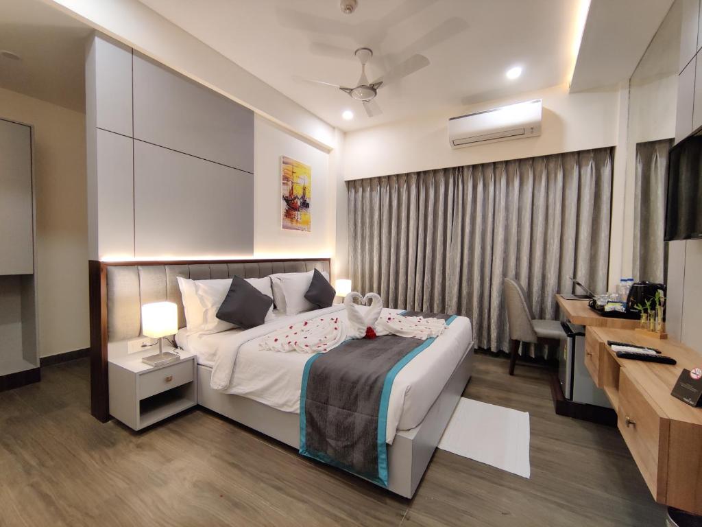 Habitación de hotel con cama, escritorio y ordenador en PARK IRIS HOTELS, Bharathi Nagar, en Vijayawāda
