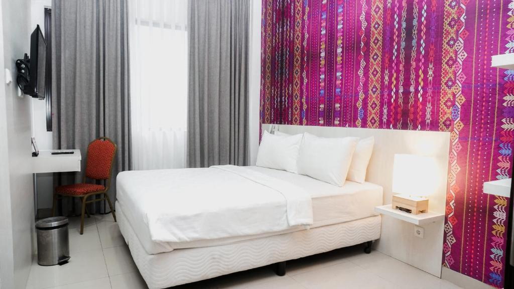 Postel nebo postele na pokoji v ubytování Alam Hotel by Cordela