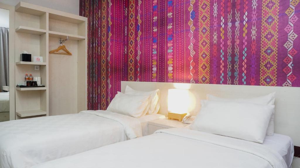 Postel nebo postele na pokoji v ubytování Alam Hotel by Cordela