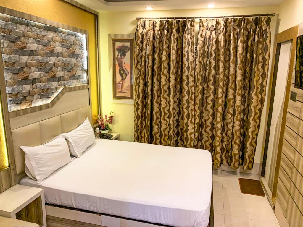 En eller flere senge i et værelse på Shila International