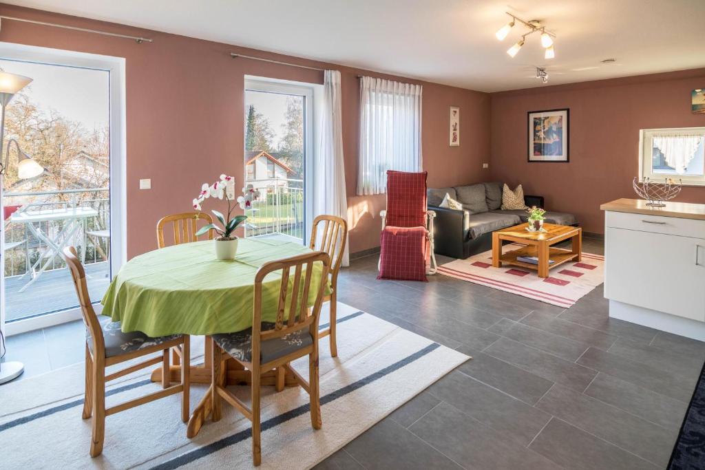 a kitchen and living room with a table and a couch at Haus Ruther - Wohnung 2 in Bad Saulgau
