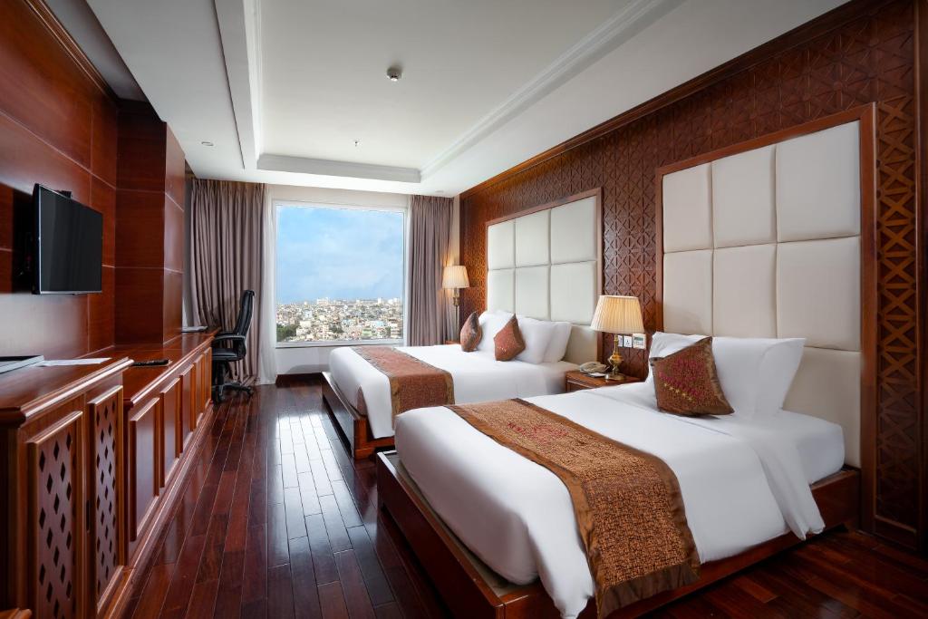 Giường trong phòng chung tại Samdi Da Nang Central Hotel