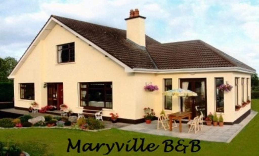a small white house with a patio at Maryville Bed and Breakfast in Nenagh
