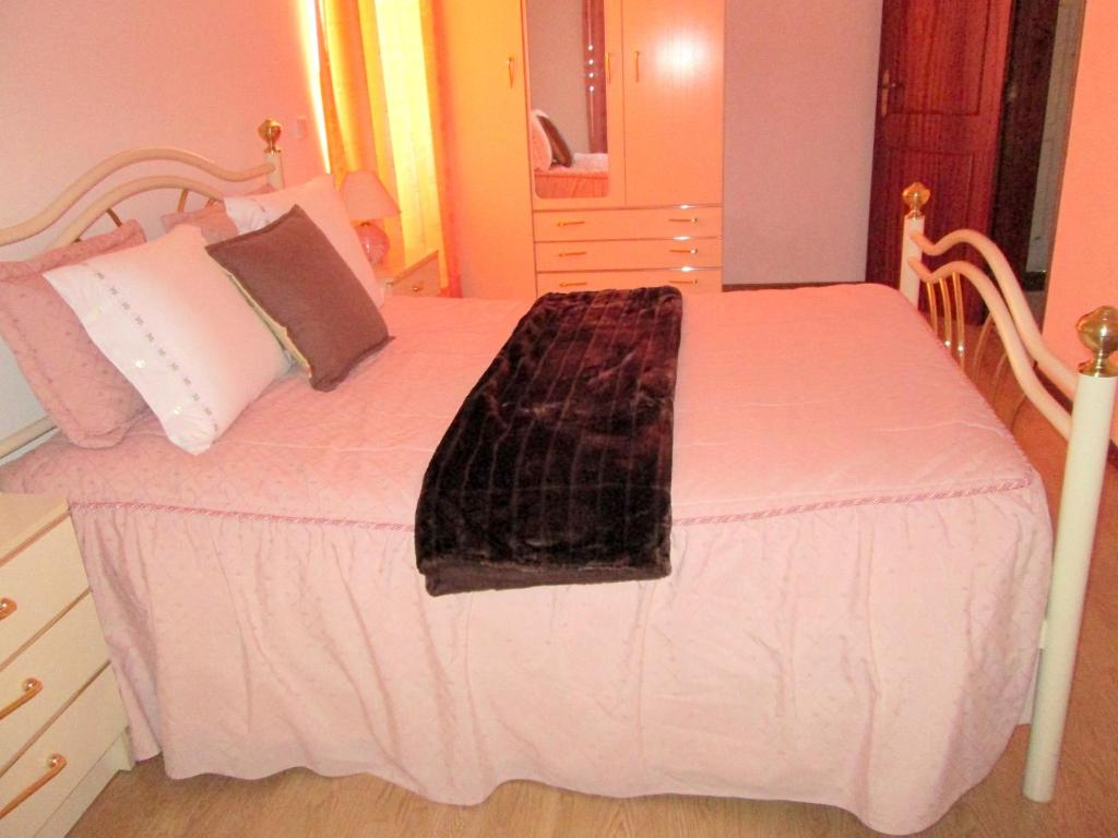 a bedroom with a bed with a white bedspread at One bedroom apartement with city view balcony and wifi at Alvoco da Serra in Alvoco da Serra