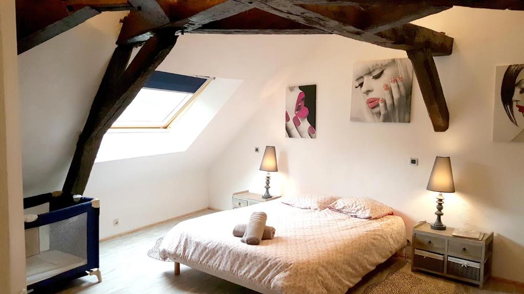 a bedroom with a bed with a teddy bear on it at Demeure de 6 chambres avec piscine interieure jacuzzi et jardin clos a Vernou sur Brenne in Vernou-sur-Brenne