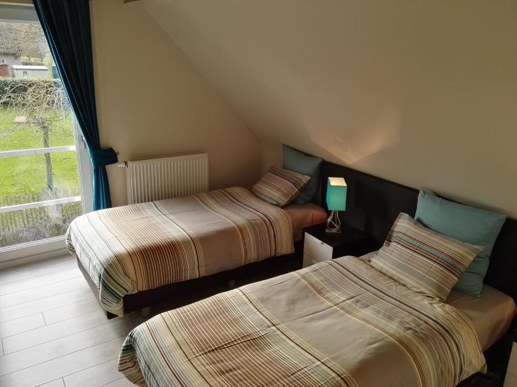 Postel nebo postele na pokoji v ubytování Archipel Holiday Cottage