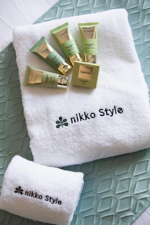 a pile of makeup products sitting on a towel at Nikko Style Nagoya in Nagoya