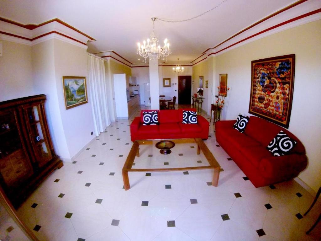 a living room with a red couch and a table at Modern Apartment in Boca Chica, 130 m², Air Conditioning Included in Boca Chica