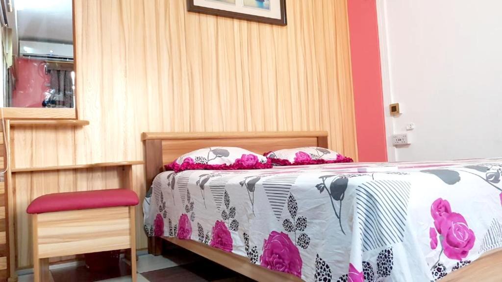 a bedroom with a bed with pink and white sheets at Modern apartment with balcony and mountain view in Souillac in Souillac
