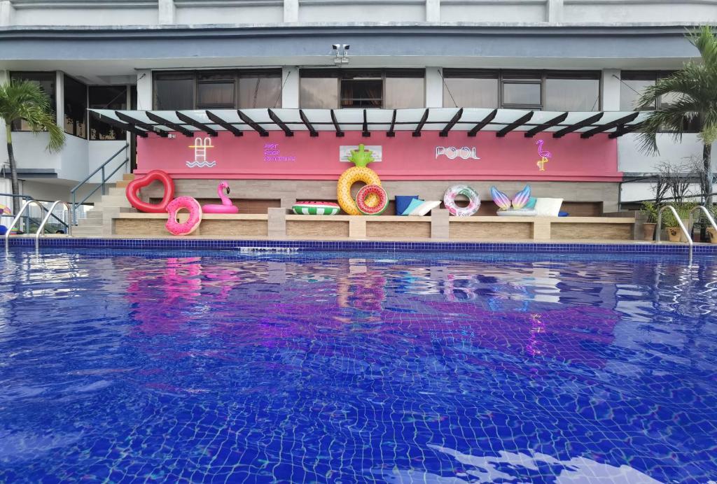 a resort with a swimming pool in front of a building at Leo Palace New Wing, WTC Kuala Lumpur in Kuala Lumpur