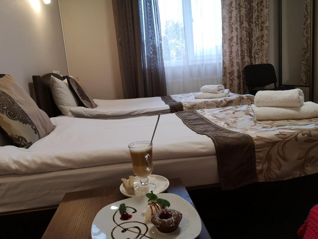 Postel nebo postele na pokoji v ubytování Orange Hotel