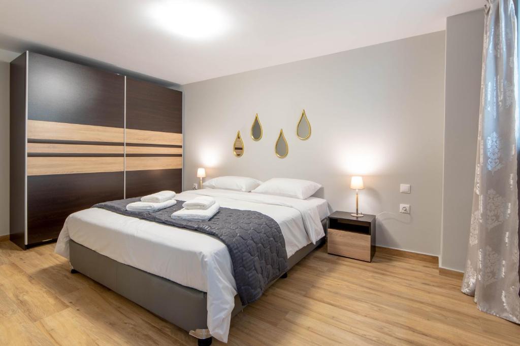 a bedroom with a large bed with white sheets at Amaryllis Maison Hili in Alexandroupoli