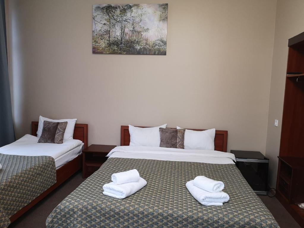 Postel nebo postele na pokoji v ubytování Orange Hotel
