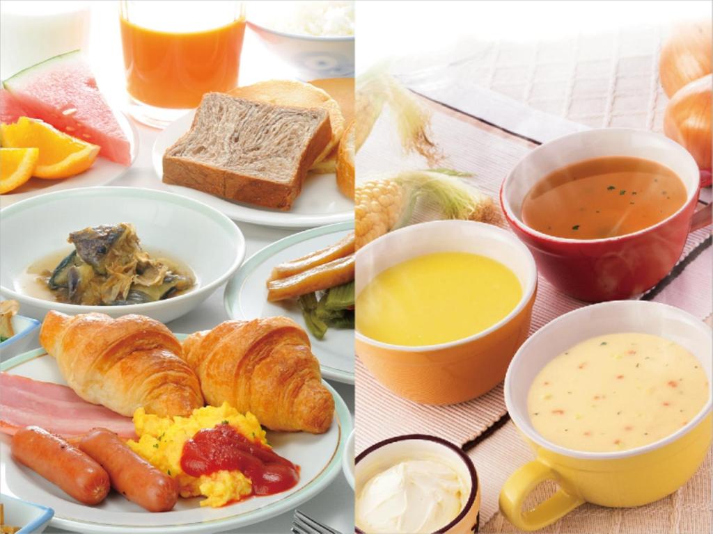 a table with plates of breakfast foods and drinks at Hotel Route-Inn Miyako in Miyako
