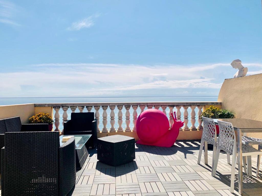 a balcony with a table and chairs and the ocean at Les Remparts Antibes Location in Antibes