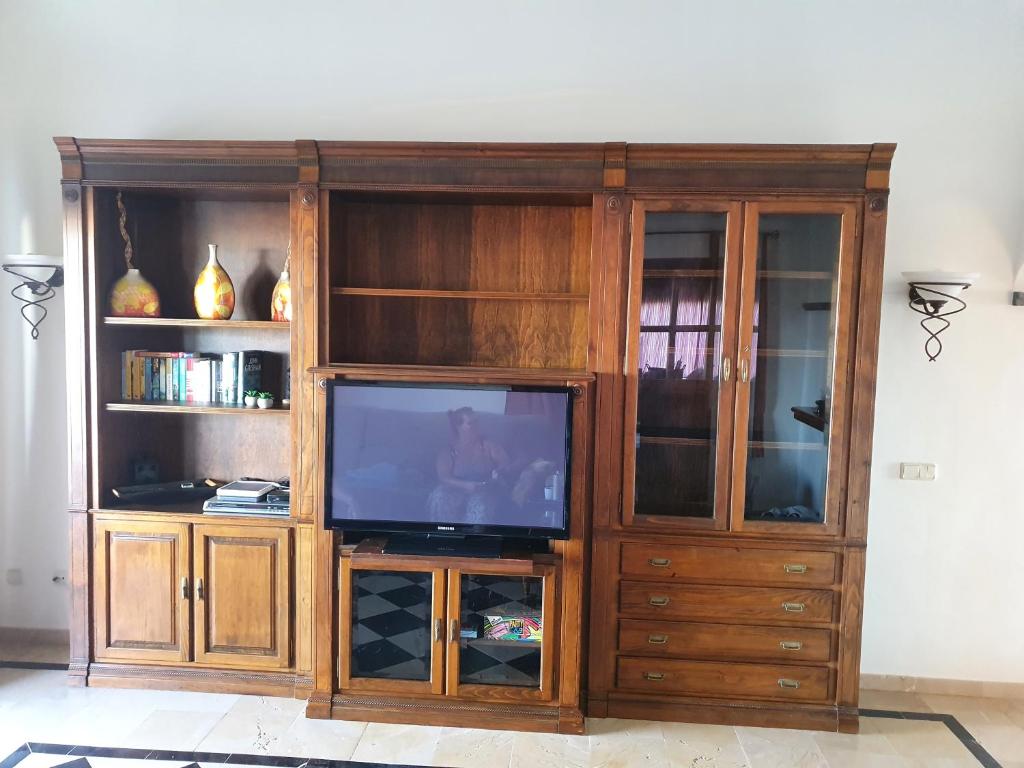 a large wooden entertainment center with a television in it at Villa Calma in Yaiza