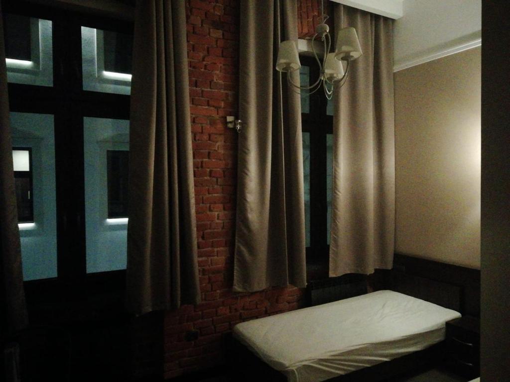 Łóżko lub łóżka w pokoju w obiekcie Aparthotel Łódź 55 Piotrkowska