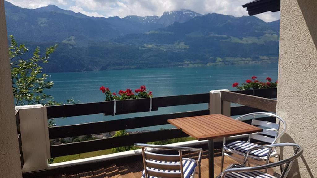 a table and chairs on a balcony with a view of a lake at Gasthaus Platten in Gersau