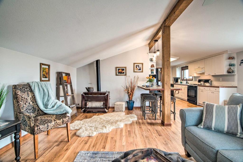 a living room with a couch and a table at Lovely Barn Loft with Mountain Views on Horse Estate in Fort Collins