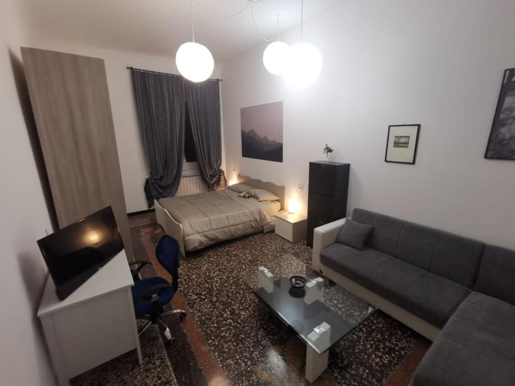 salon z kanapą i łóżkiem w obiekcie Wow Home - 175 mq - posteggio privato - davanti porto traghetti - fino a 10 posti letto w Genui