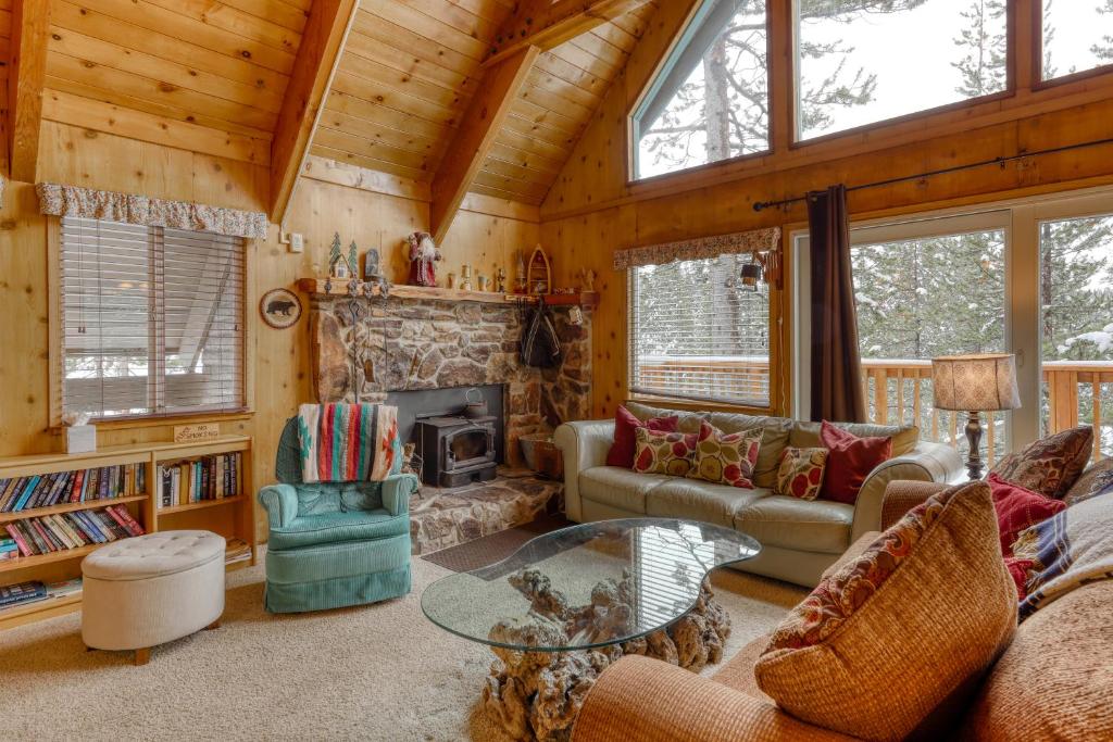 a living room with a fireplace in a log cabin at Serene Escape in Soda Springs