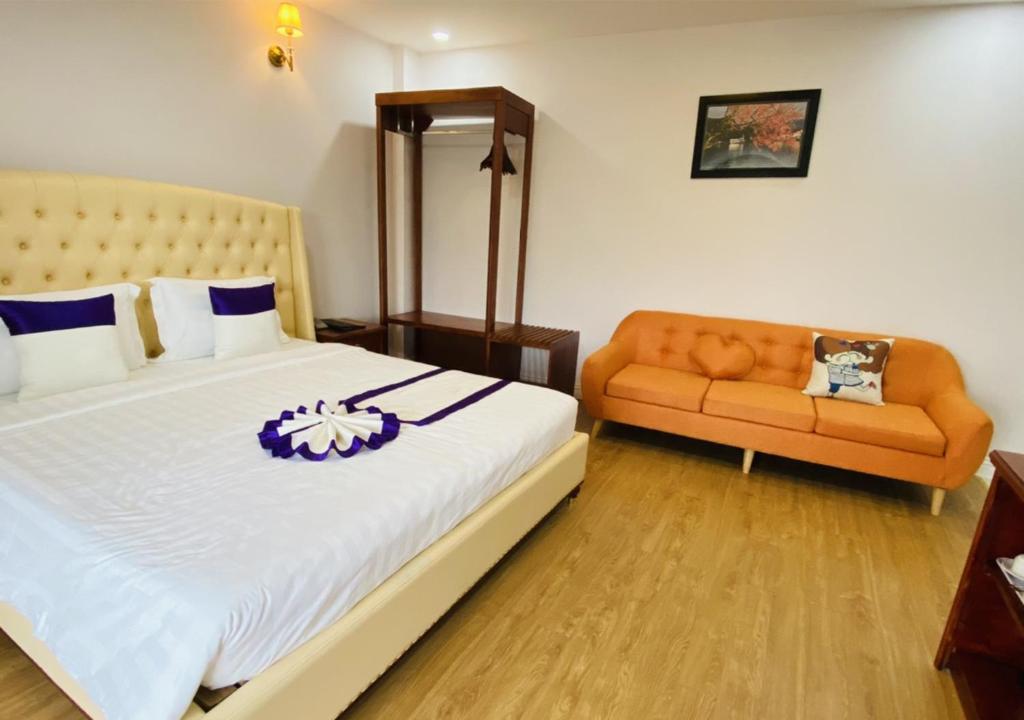Postel nebo postele na pokoji v ubytování Peach Valley Hotel Dalat