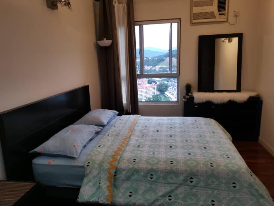 a bedroom with a bed and a window with a view at Seri Maya -Lrt setiawangsa - Master Room with shared unit in Kuala Lumpur