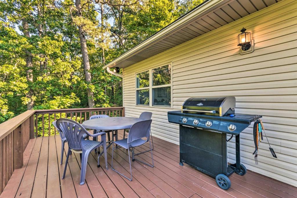 a grill on a deck with a table and chairs at Hot Springs Escape Less Than 2 Miles to the Lake! in Hot Springs Village