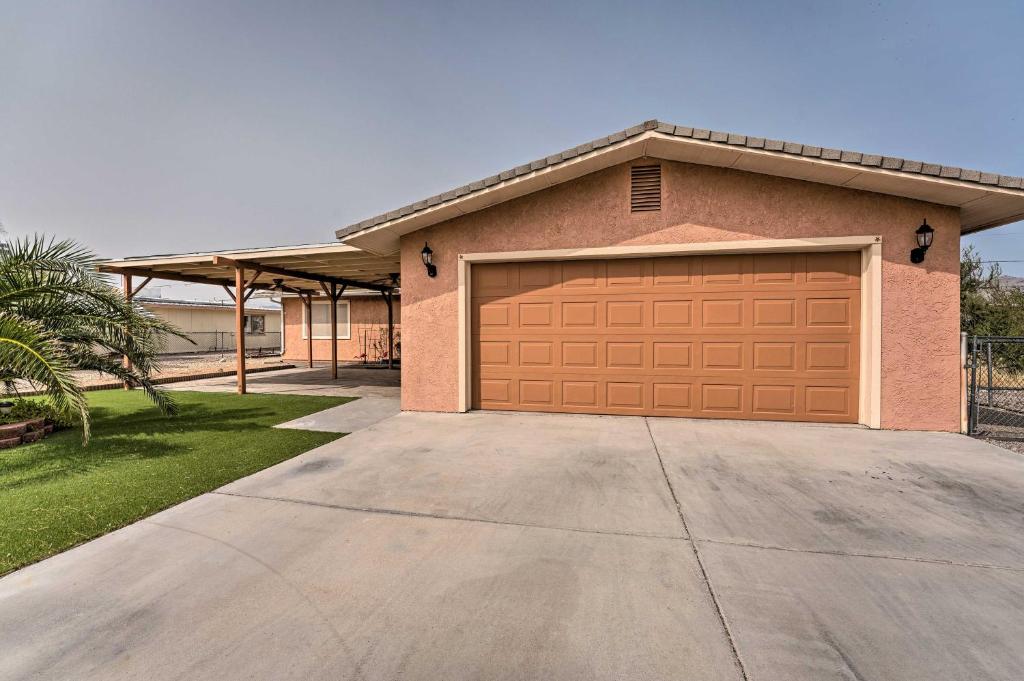 a garage door on a house with a driveway at Updated Family Home - 2 Blocks to Colorado River! in Bullhead City