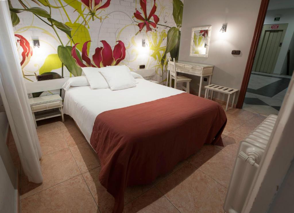 Postel nebo postele na pokoji v ubytování Hotel Alfonso IX