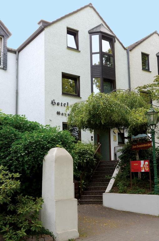 a white building with stairs in front of it at Zum Bergischen Hof in Dormagen