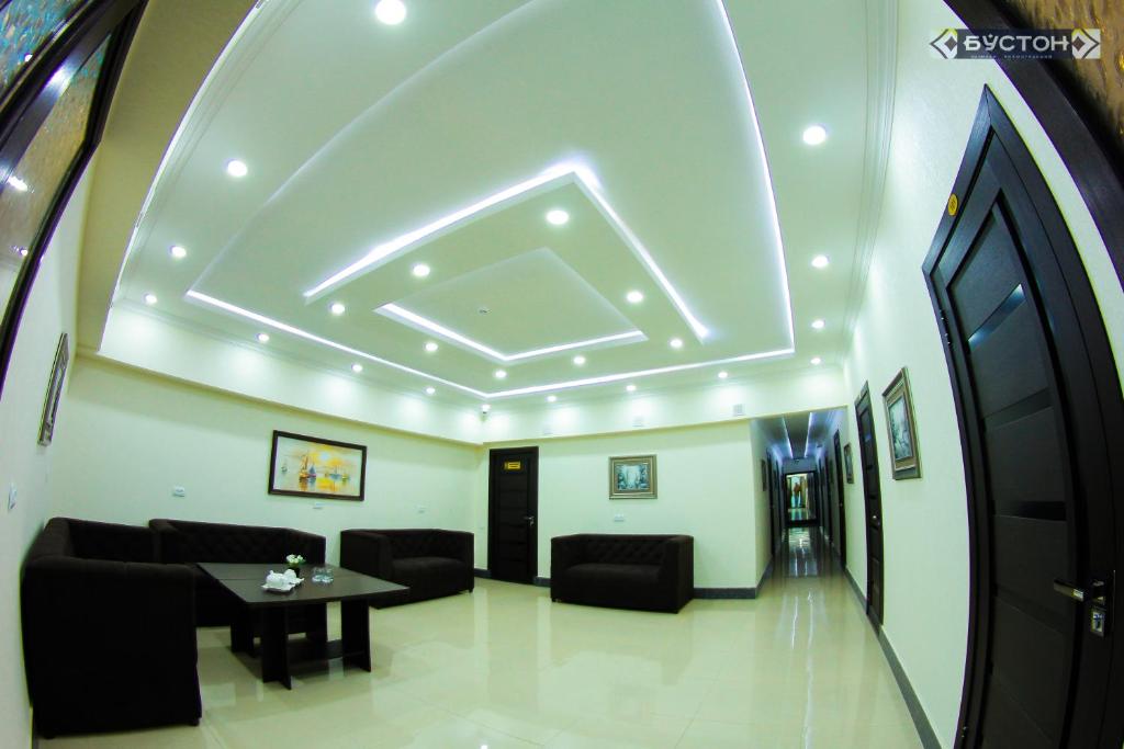 a living room with a coffered ceiling and a table at Hostel Buston in Chkalovsk