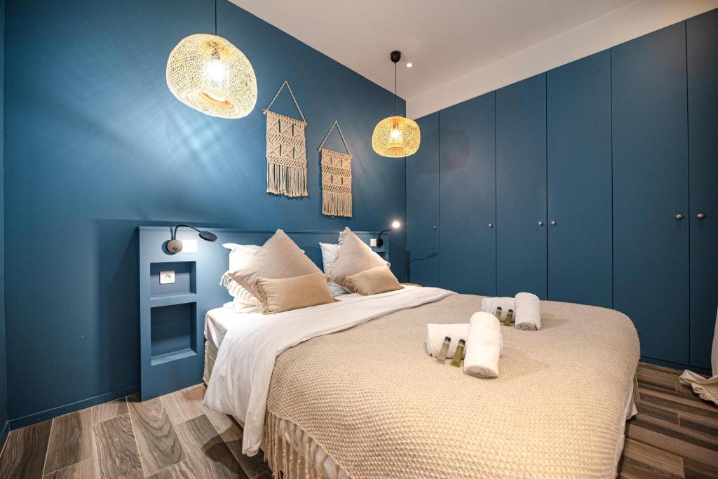 a bedroom with two beds with blue walls and lights at Lovely Home in Paris Center - AC in Paris