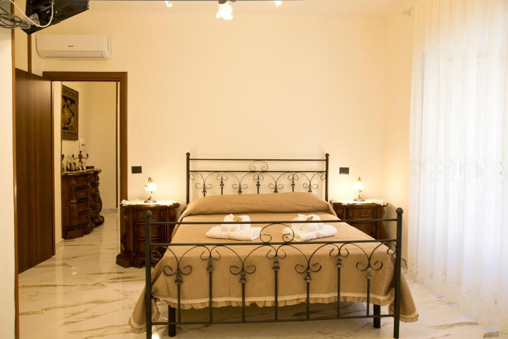 a bedroom with a bed and two night stands at B&B Serena in Castellammare di Stabia