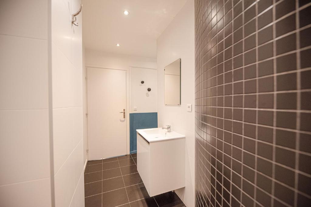 a bathroom with a white toilet and a sink at Lovely Home in Paris Center - AC in Paris