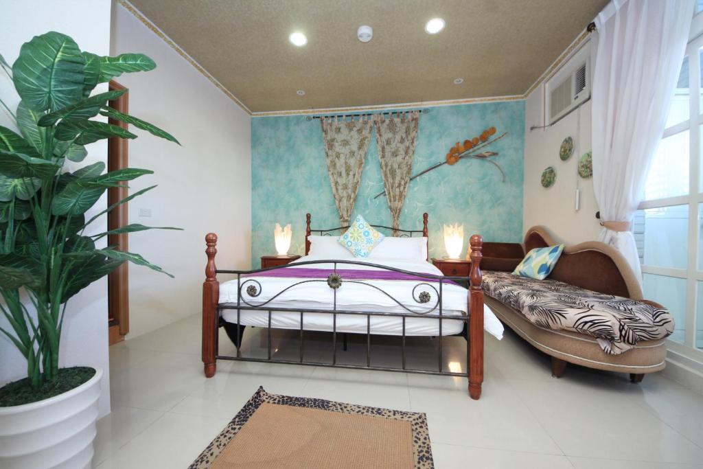 una camera con letto e pianta in vaso di Avica Homestay a Wujie