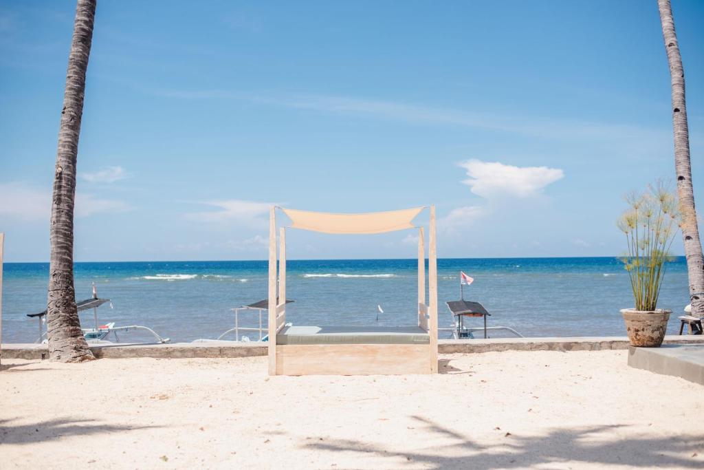 a tent on the beach with the ocean in the background at New Sunari Lovina Beach Resort in Lovina