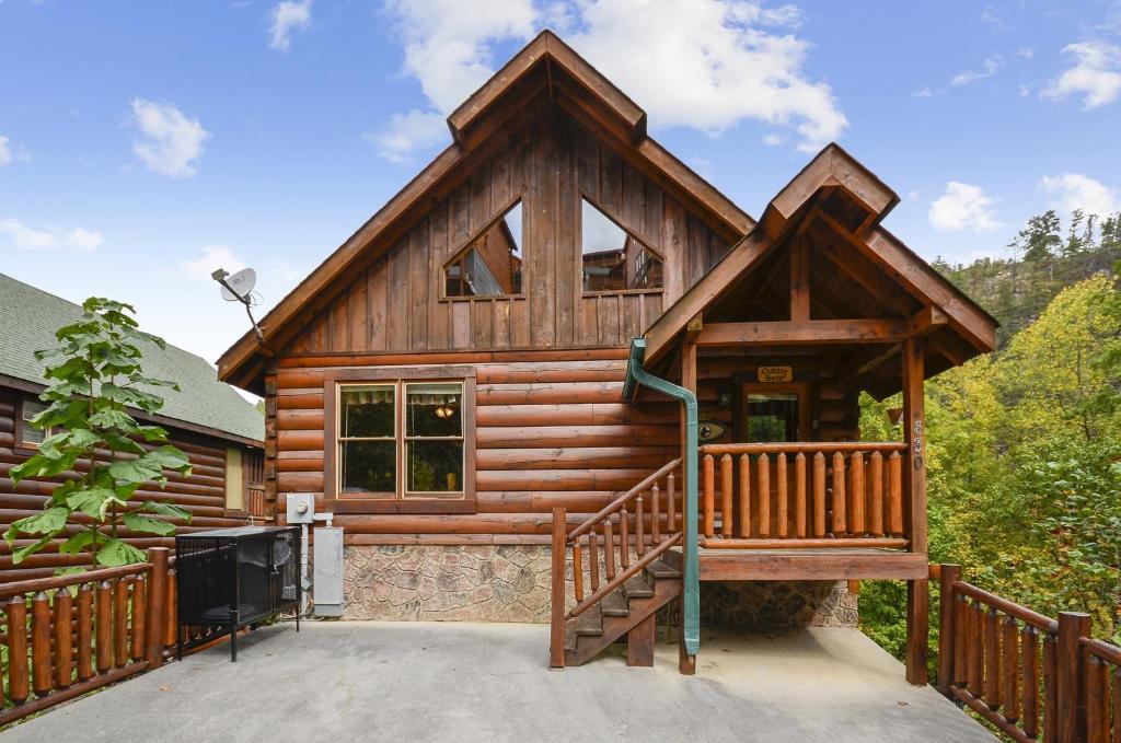 a log cabin with a large porch and a balcony at Spacious Cubby Bear Cabin in Sevierville