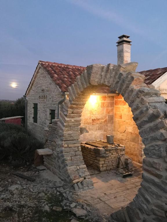 a large stone oven in front of a house at Country House Olive Garden in Gorica
