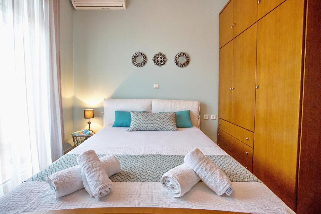 a bedroom with a large bed with two pillows on it at Joy cozy apartment in Iraklitsa