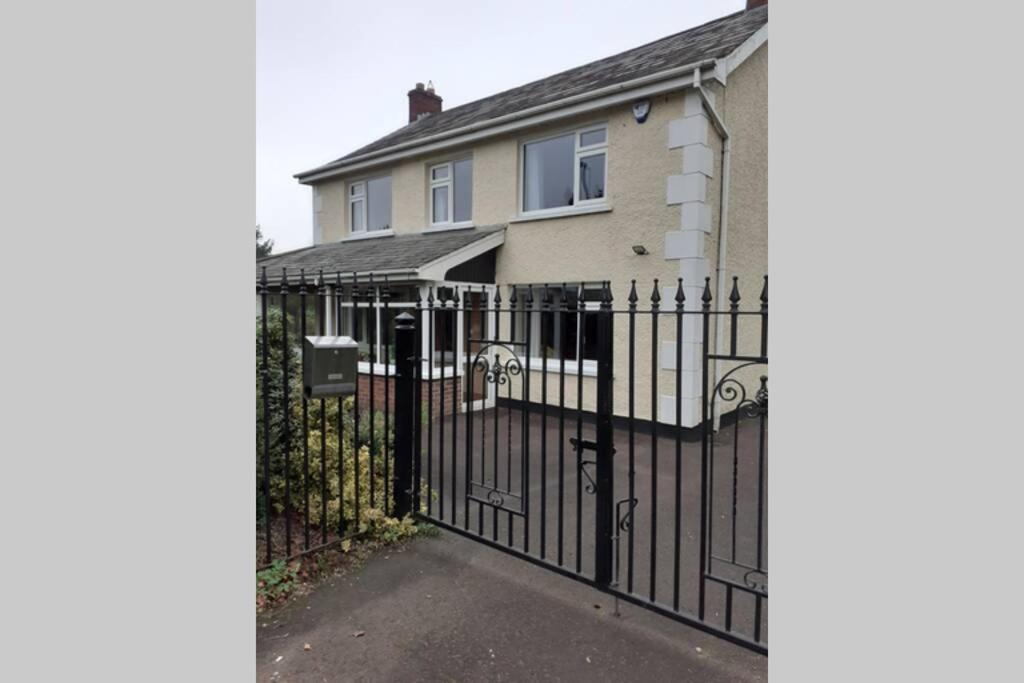 a black wrought iron fence in front of a house at Umry Lodge in Antrim