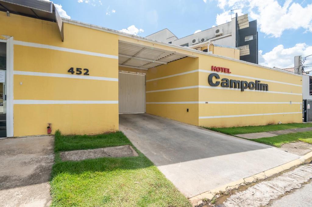 a yellow building with a sign on the side of it at Hotel Campolim in Sorocaba